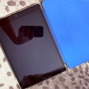 Apple Tablet with Black Screen and Blue Cover